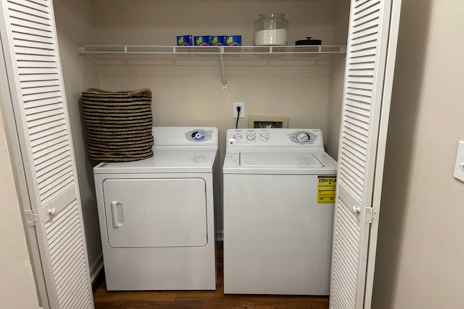 A small laundry room with a washer and dryer.